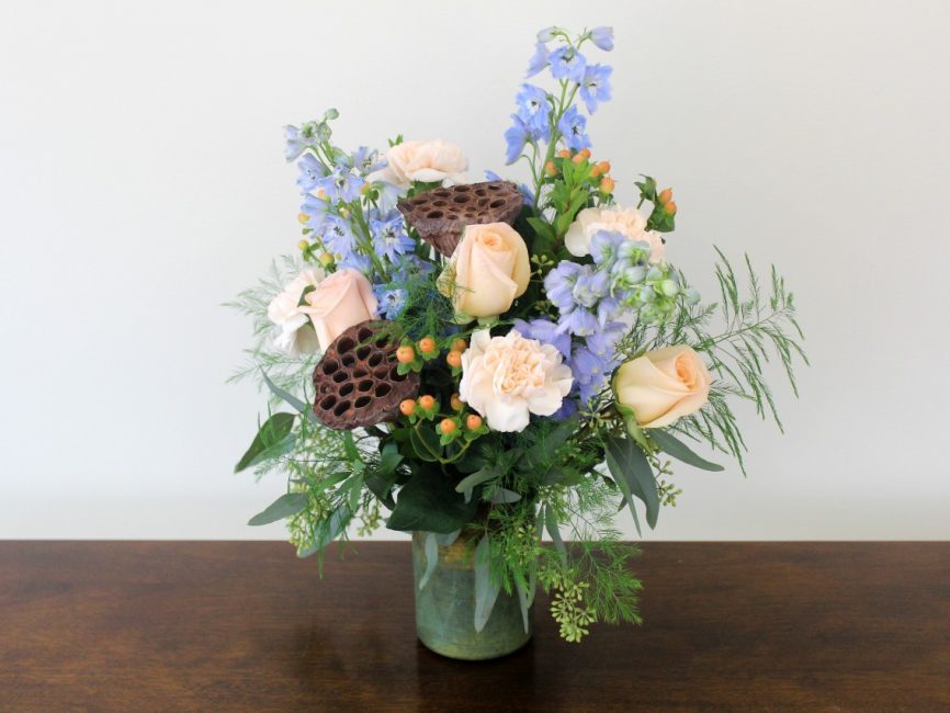 Virgo bouquet with pale peach and light blue flowers by Studley Flower Gardens