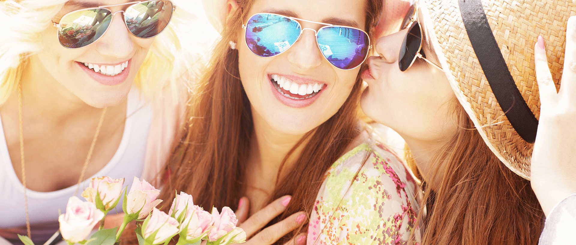 three women in sunglasses give birthday flowers