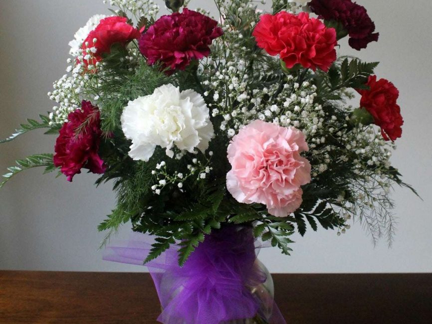 Classic carnation bouquet in a clear vase by Studley Flower Gardens