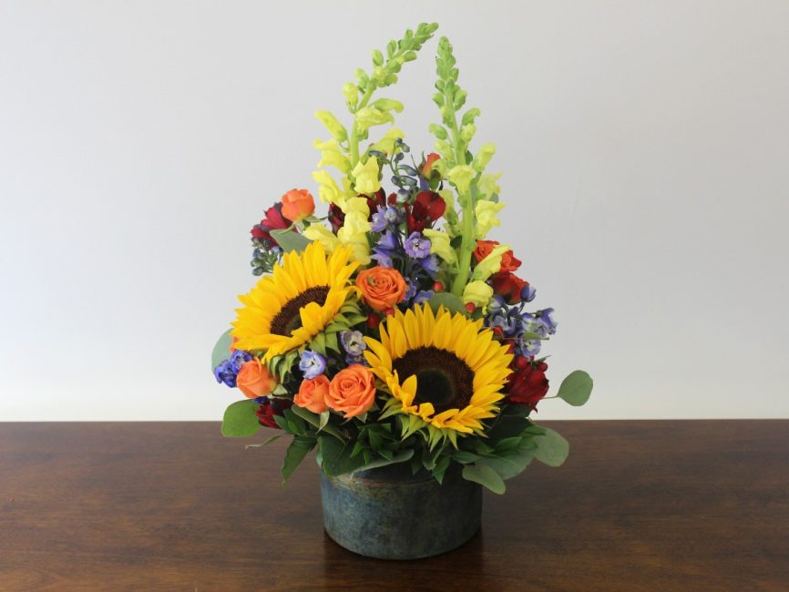Leo bouquet with golden yellow, orange, and red flowers by Studley Flower Gardens